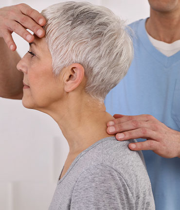 Patient receiving chiropractic adjusmtent for migraine relief from Akron Chiropractors