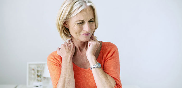 Mature woman suffering from neck and shoulder pain before visiting Akron chiropractor